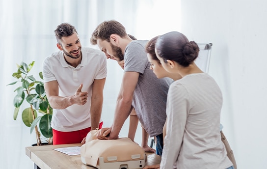 group-of-people-with-cpr-dummy-during-first-aid-tr