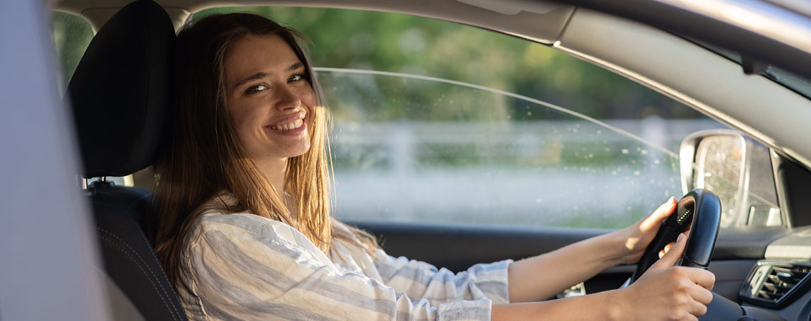 young-girl-sit-at-driver-seat-in-new-car-smiling-h