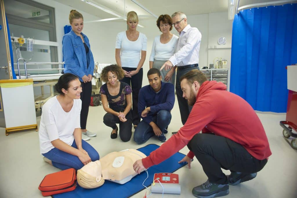 Defibrillator-Training während eines Erste-Hilfe-Kurses.